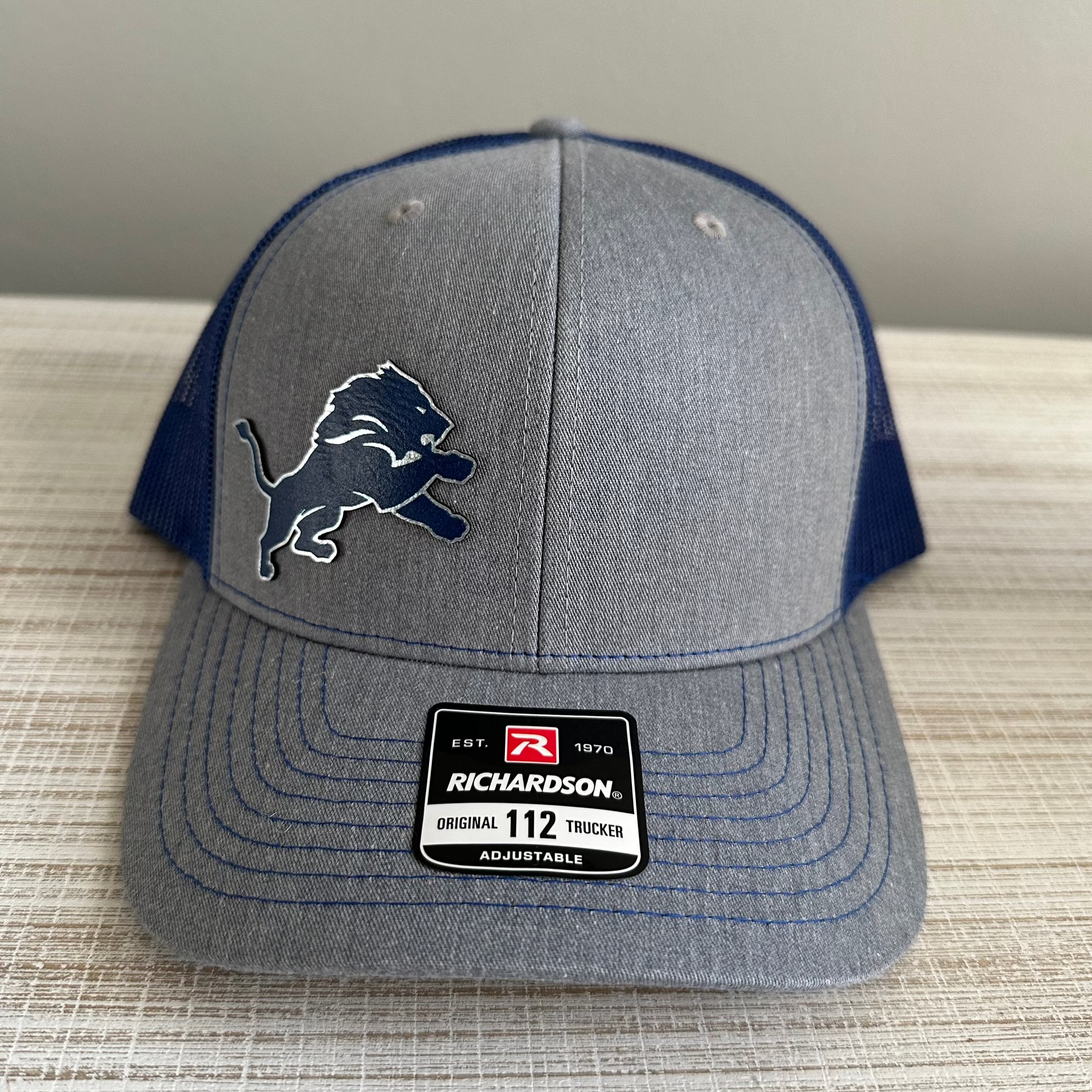 Lions Leatherette Patch Trucker Hat – Grey with Blue and Silver