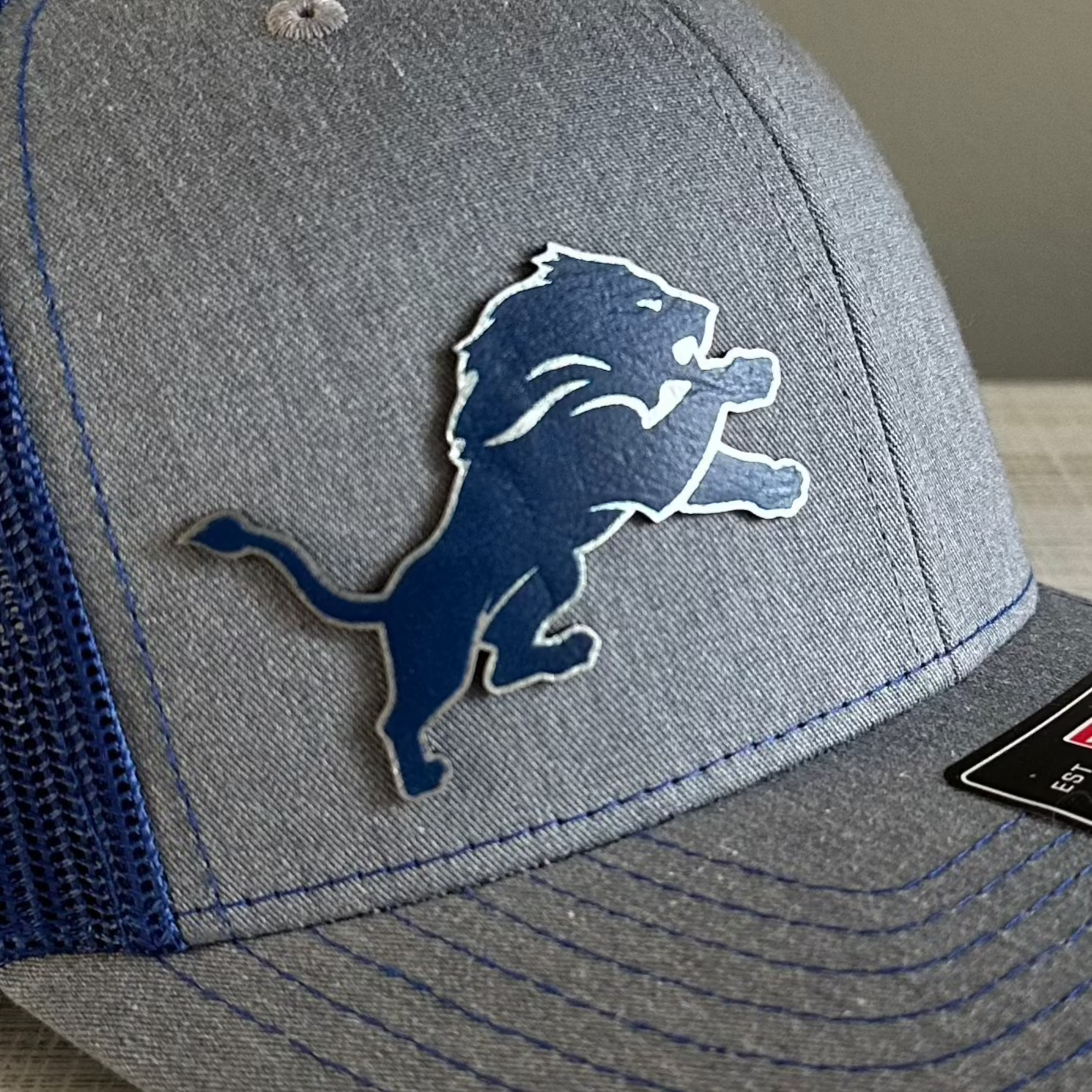 Lions Leatherette Patch Trucker Hat – Grey with Blue and Silver Patch